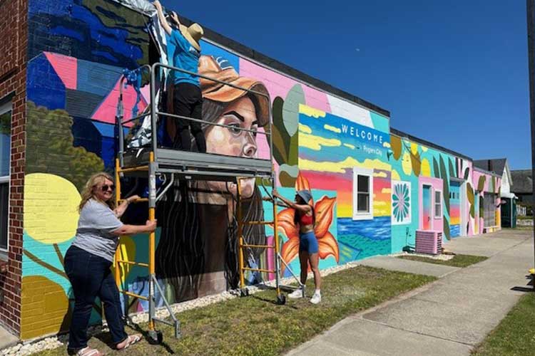 Mural artist Irene Lopez Leon working on the mural in progress 